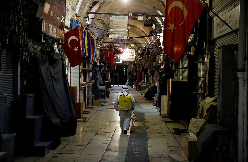 A worker in a protective suit sprays disinfectant at Grand Bazaar, known as the Covered Bazaar, to prevent the spread Covid-19 in Istanbul, Turkey March 25, 2020. u00e2u20acu201d Reuters pic