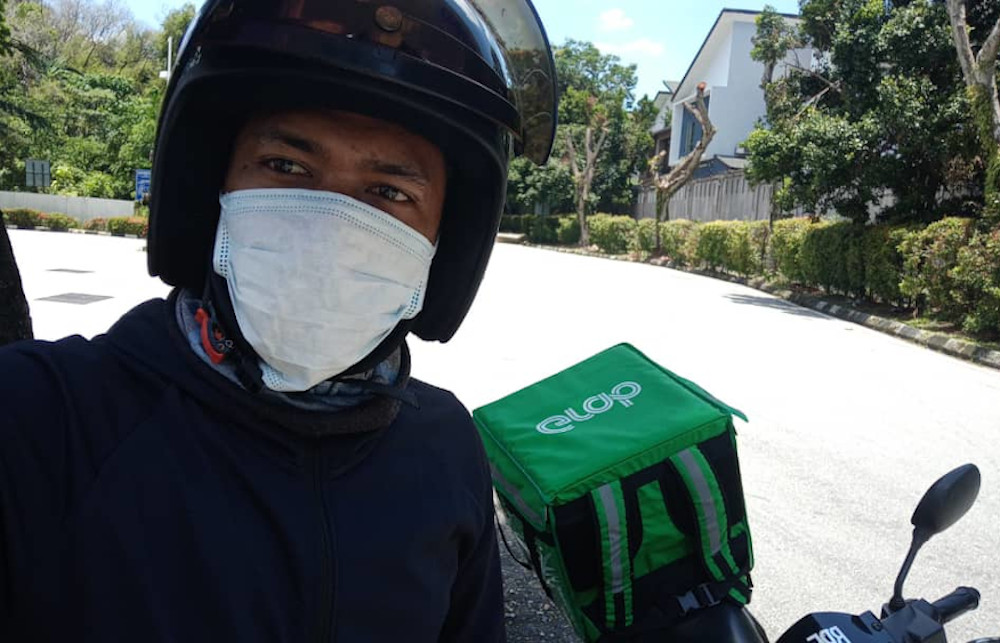 As a frontline worker during the shutdown, GrabFood rider Muhammad Asri Mohamad Ibrahim has been taking every precaution to stay clean. u00e2u20acu201d Picture courtesy of GrabFood