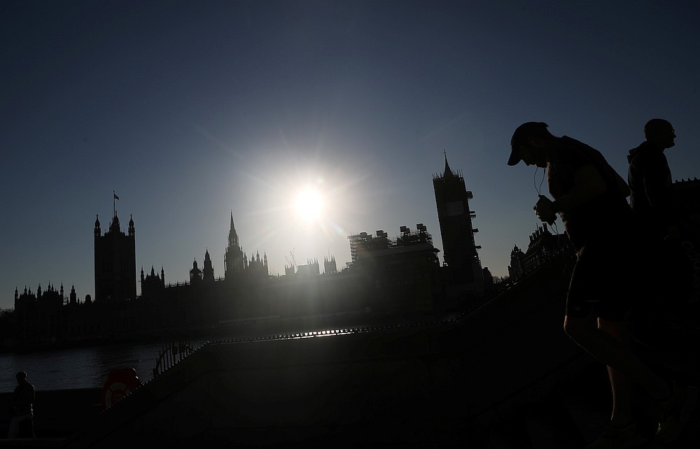 A man jogs past the Houses of Parliament in Westminster, as the spread of Covid-19 continues, in London, Britain March 25, 2020. u00e2u20acu201d Reuters pic