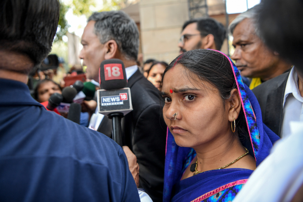 AP Singh (left), advocate of Akshay Thakur, one of the four men convicted of the gang-rape and murder case of a student, speaks to media representatives along with Thakuru00e2u20acu2122s wife, Punita Devi (right), outside the Patiala House Court in New Delhi March 19