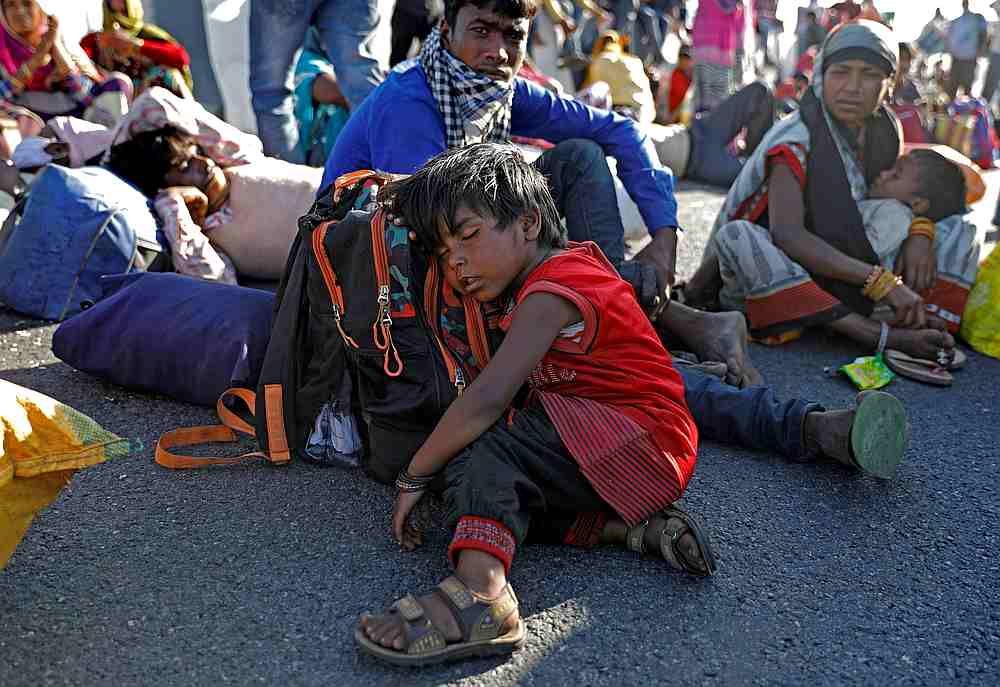 The daughter of a migrant worker sleeps on a highway as her family failed to get a bus to return to their village, during the Covid-19 lockdown in New Delhi, India March 29, 2020. u00e2u20acu201d Reuters pic