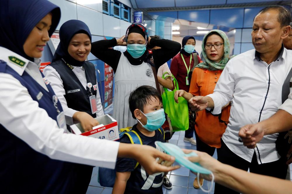 Indonesiau00e2u20acu2122s commuter train officials distribute free-protective masks to the passengers following confirmed cases of the novel coronavirus disease of Covid-19 in Jakarta, Indonesia, March 3, 2020. u00e2u20acu201d Reuters pic