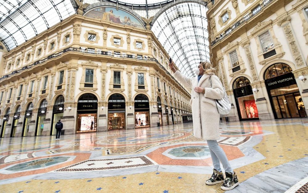 A woman wearing a protective face mask takes a selfie in Galleria Vittorio Emanuele II after a decree orders for the whole of Italy to be on lockdown in an unprecedented clampdown aimed at beating the coronavirus, in Milan, Italy, March 10, 2020. u00e2u20acu201d Reut