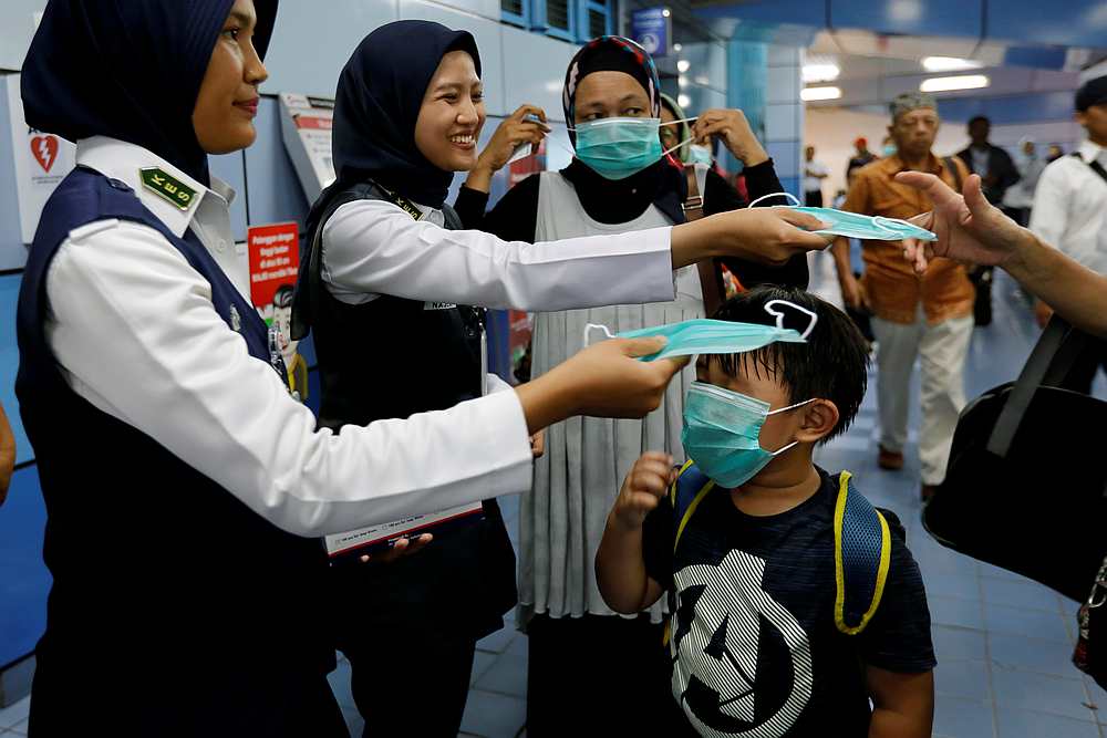 Indonesia's commuter train officials distribute free protective masks to passengers in Jakarta, Indonesia March 3, 2020. u00e2u20acu201d Reuters pic
