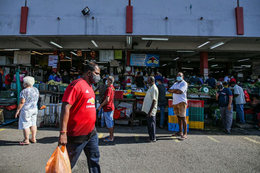 Customers observe social distancing guidelines as they queue outside Pasar Besar Jalan Othman in Petaling Jaya March 26, 2020. u00e2u20acu201d Picture by Hari Anggara