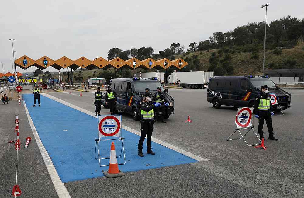 Border police officers wait to check vehicles at the last toll gate entering Spain from France, in La Jonquera March 17, 2020. u00e2u20acu201d Reuters pic