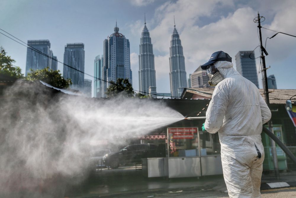 An Alam Flora personnel sprays disinfectant in Kampung Baru to curb spread of Covid-19 in Kuala Lumpur March 31, 2020. u00e2u20acu201d Picture by Ahmad Zamzahuri
