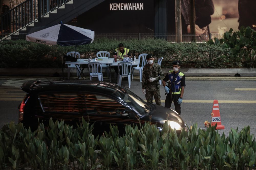 Malaysian Armed Forces and police personnel man a roadblock on Jalan Ampang March 24, 2020. u00e2u20acu201d Picture by Ahmad Zamzahuri