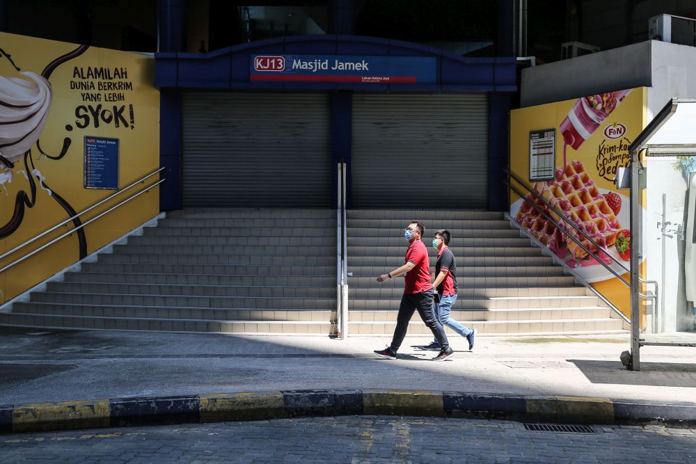 People walk past the Masjid Jamek LRT station in Kuala Lumpur on day eight of the movement control order March 25, 2020. u00e2u20acu201d Picture by Yusof Mat Isa