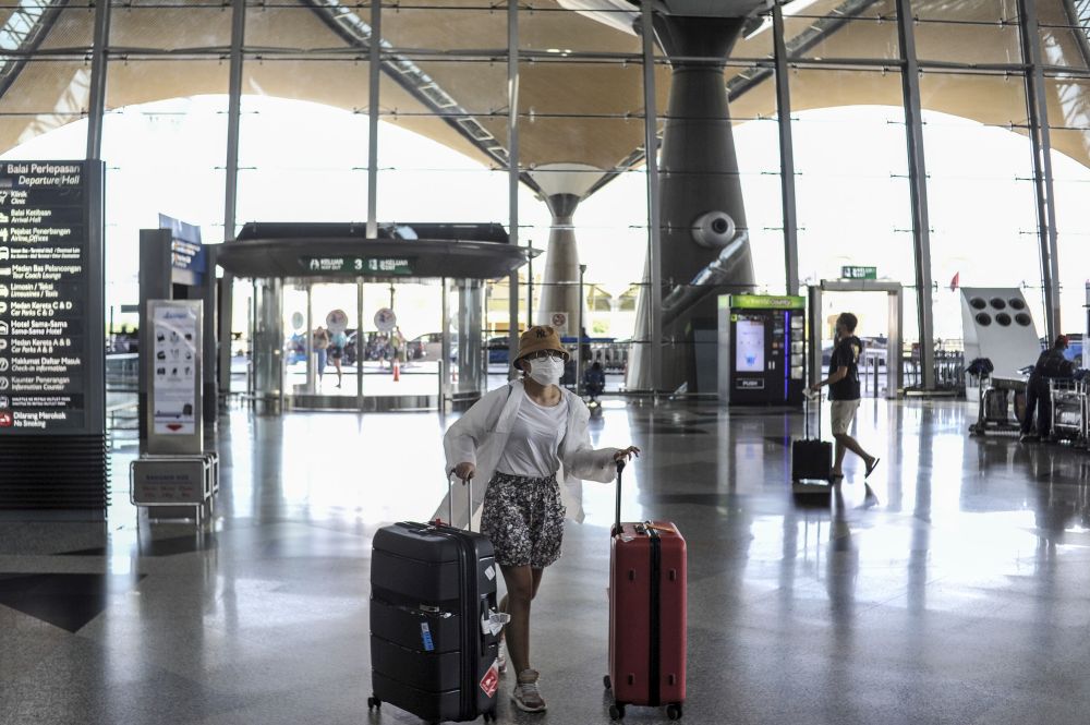 Travellers are pictured at the Kuala Lumpur International Airport in Sepang March 17, 2020. u00e2u20acu201d Picture by Shafwan Zaidon