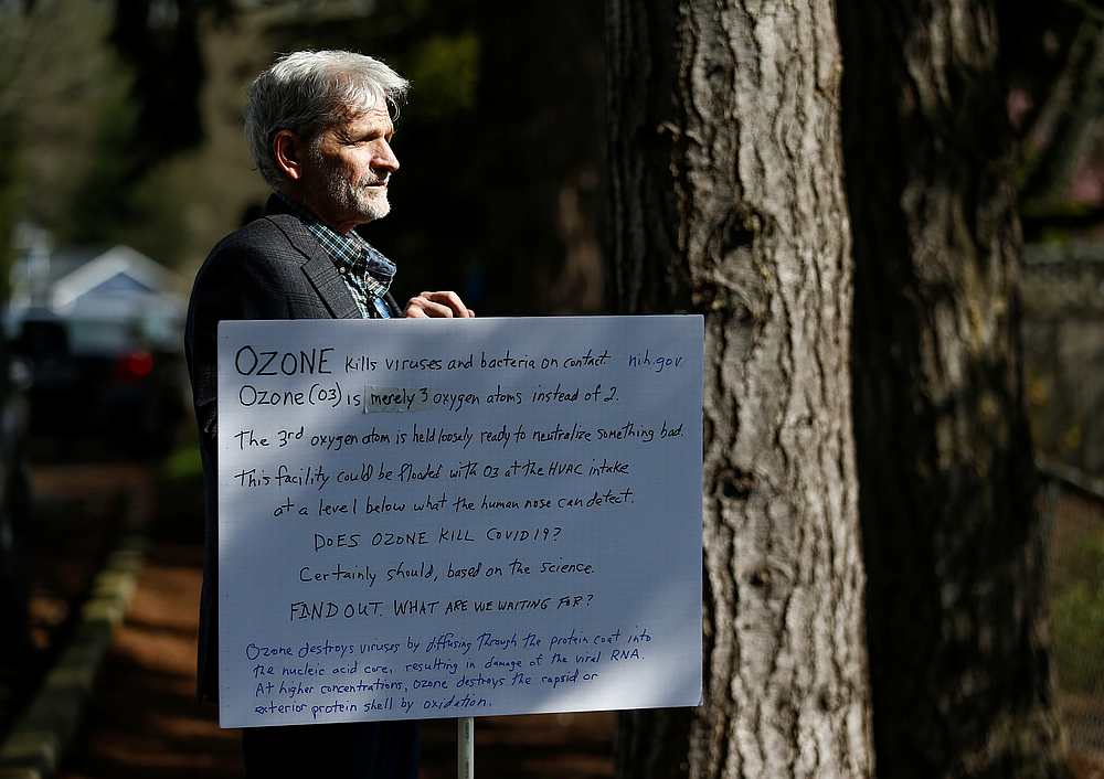 Gary Hawkins of Seattle holds a sign suggesting using ozone to resolve coronavirus, outside the Life Care Center of Kirkland, Washington March 8, 2020. u00e2u20acu201d Reuters pic
