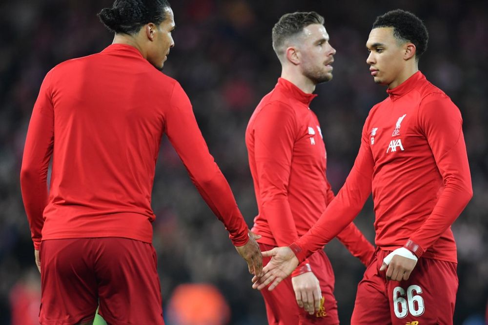 Liverpoolu00e2u20acu2122s Virgil van Dijk (left), Jordan Henderson (centre) and Trent Alexander-Arnold gesture before the Uefa Champions league Round of 16 second leg match between Liverpool and Atletico Madrid at Anfield in Liverpool, England, March 11, 2020. u00e2u20acu201d AF