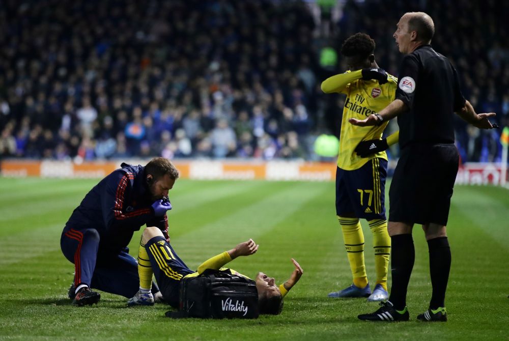 Arsenal's Lucas Torreira reacts after sustaining an injury against Portsmouth whilst referee Michael Dean and Bukayo Saka look on. u00e2u20acu201d Reuters picnn