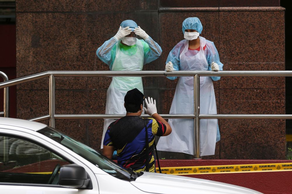 Health workers gear up before entering Menara City One in Kuala Lumpur March 31, 2020. u00e2u20acu201d Picture by Yusof Mat Isa