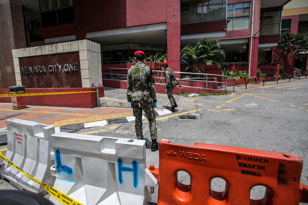 Police and Armed Forces personnel patrol the vicinity of Menara City One in Kuala Lumpur March 31, 2020. u00e2u20acu201d Picture by Hari Anggarann
