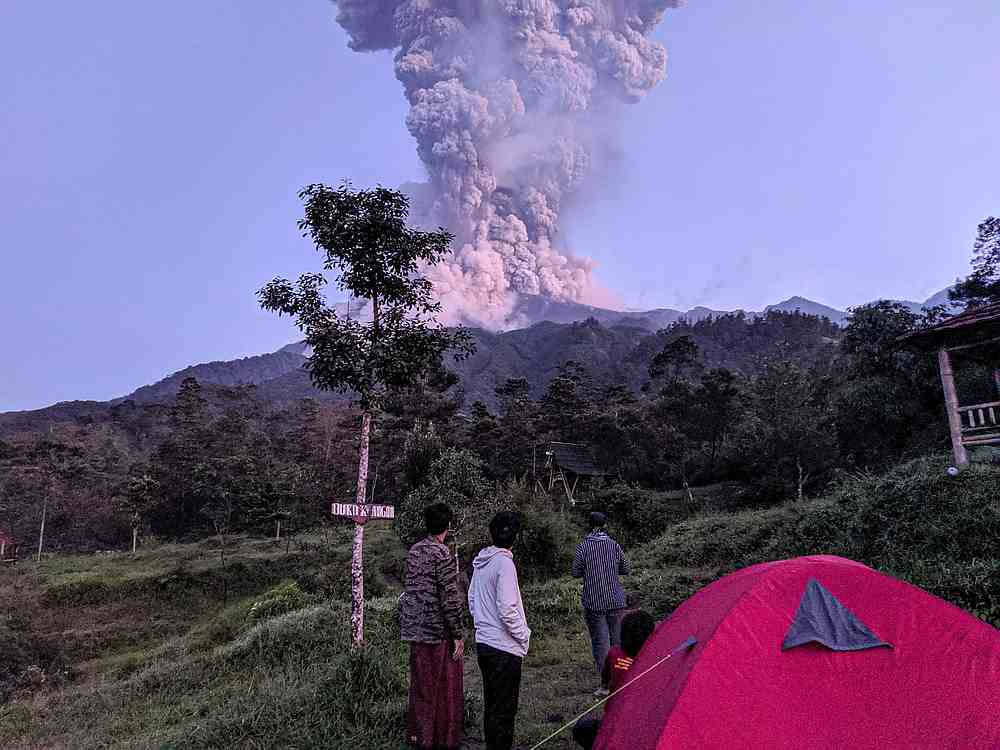 Tourists look towards Mount Merapi volcano as it erupts, at Cangkringan district in Sleman, Yogyakarta, Indonesia March 3, 2020. u00e2u20acu201d Antara Foto/Rizky Tulus via Reuters 