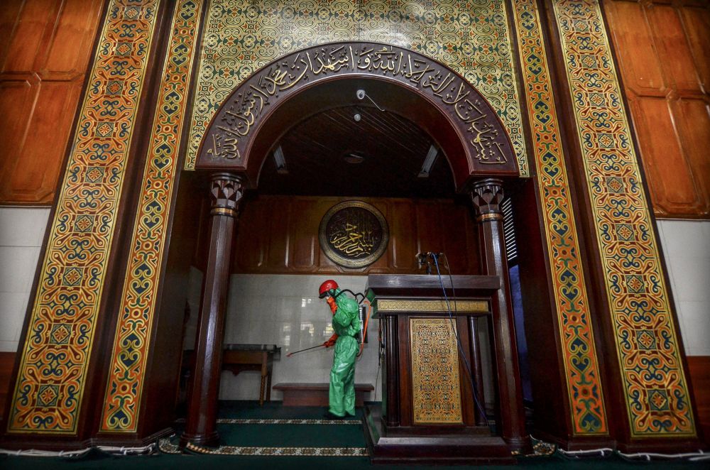 A medical officer sprays disinfectant in mosque amid the coronavirus disease outbreak in Tasikmalaya, Indonesia, March 18, 2020. u00e2u20acu201d Reuters pic