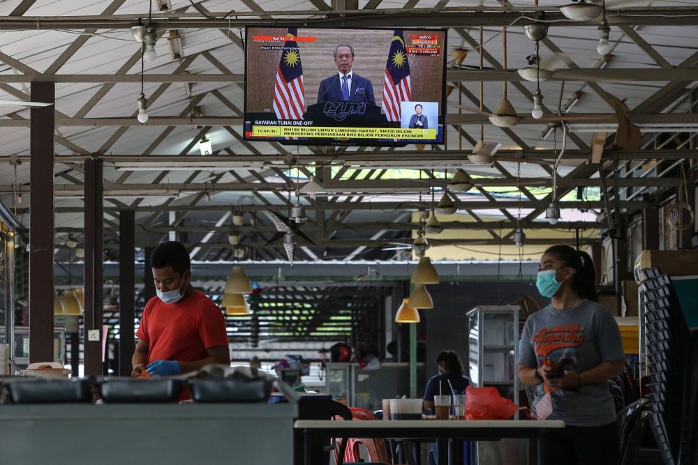A live broadcast of Prime Minister Tan Sri Muhyiddin Yassin on the special Covid-19 stimulus package is seen on a television in Kuala Lumpur March 27, 2020. u00e2u20acu2022 Picture by Yusof Mat Isa