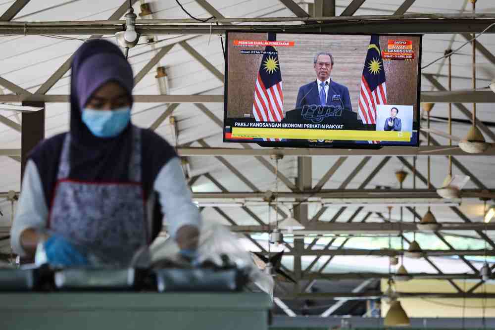 A live broadcast of Prime Minister Tan Sri Muhyiddin Yassin on the special Covid-19 stimulus package is seen on a television in Kuala Lumpur March 27, 2020. u00e2u20acu2022 Picture by Yusof Mat Isa