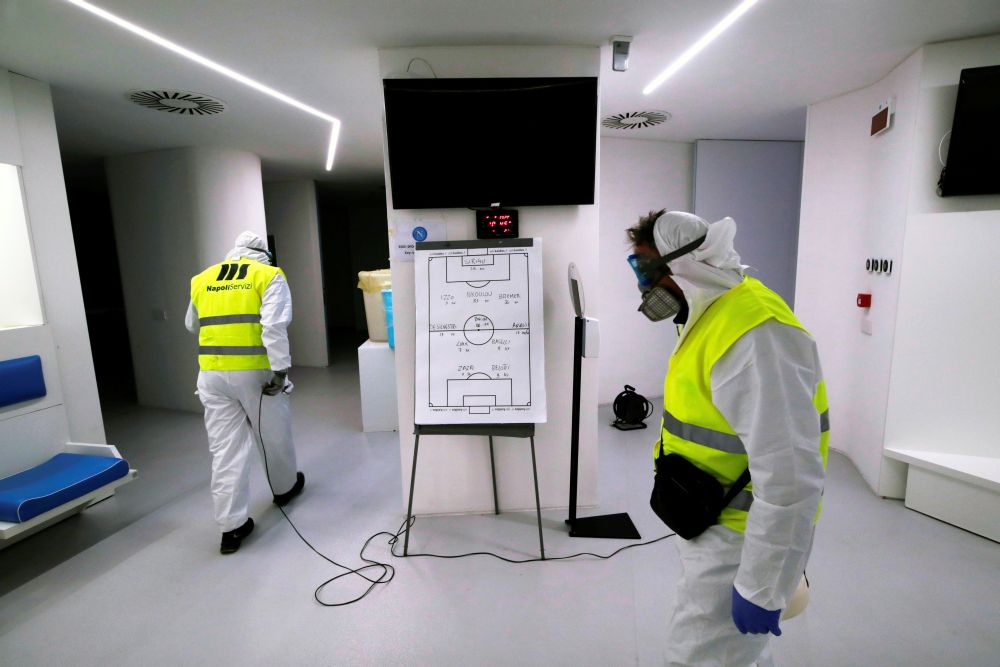 Cleaners wearing protective suits sanitise locker rooms at the San Paolo stadium ahead of the second leg of the Coppa Italia semi-final between Napoli and Inter Milan March 4, 2020. u00e2u20acu201d Reuters picn n