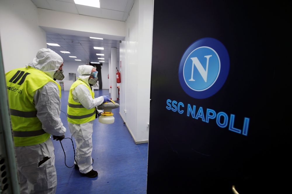 Cleaners wearing protective suits sanitise locker rooms at the San Paolo stadium ahead of the second leg of the Coppa Italia semi-final between Napoli and Inter Milan March 4, 2020. u00e2u20acu201d Reuters picn n