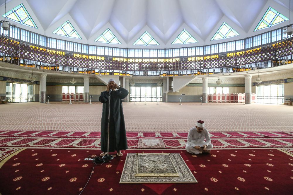 National Mosque Bilal Mohd Fakhrurazi Mohd Yusof in a call of u00e2u20acu02dcazanu00e2u20acu2122 on Day Three of the movement control order in Kuala Lumpur March 20, 2020. u00e2u20acu201d Picture by Yusof Mat Isa