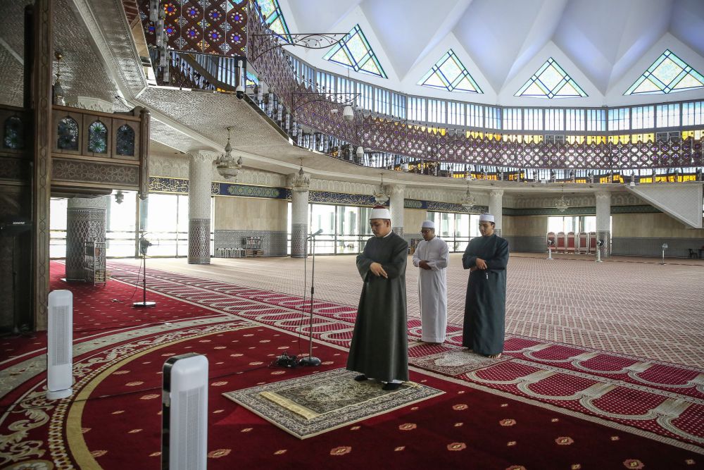 National Mosque Imam Mohamad Alif Jamal leads u00e2u20acu02dcZuhuru00e2u20acu2122 prayers on Day Three of the movement control order in Kuala Lumpur March 20, 2020. u00e2u20acu201d Picture by Yusof Mat Isa