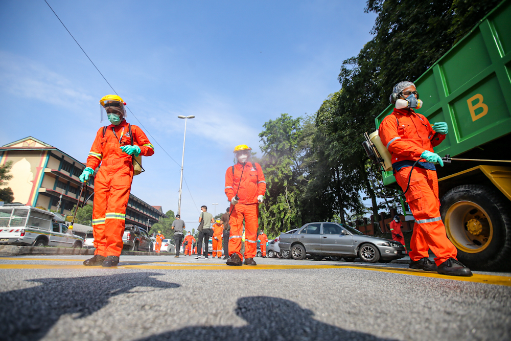 DBKL and Alam Flora personnel sanitise the area around the Sri Petaling Mosque March 28, 2020. u00e2u20acu2022 Picture by Hari Anggara