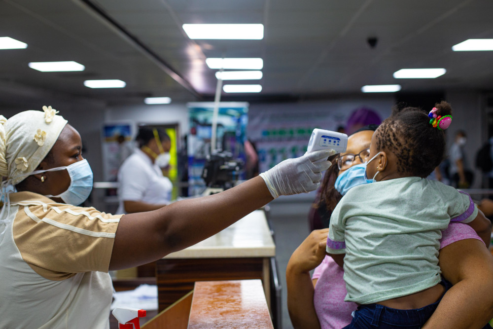 A mother and childu00e2u20acu2122s body temperatures are being tested at the gate of entry upon arrival at the Murtala International Airport in Lagos, March 2, 2020. Cameroon confirmed its first case of the Covid-19 March 6, 2020. u00e2u20acu201d AFP pic 