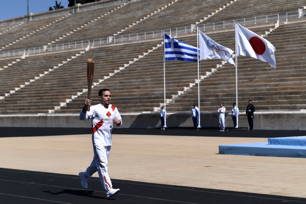 An athlete carries the olympic torch during the olympic flame handover ceremony for the 2020 Tokyo Summer Olympics March 19, 2020. u00e2u20acu201d Reuters pic