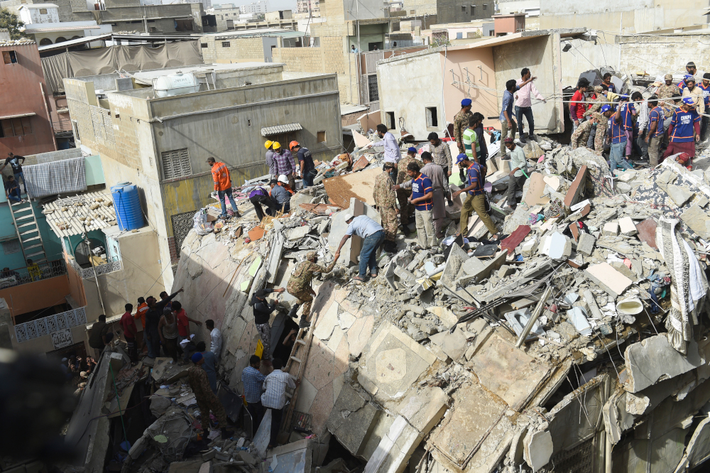 Pakistani volunteers, security personnel and residents search for the victims in the rubble of a collapsed a five-storey residential building in Karachi on March 5, 2020. u00e2u20acu201d AFP pic
