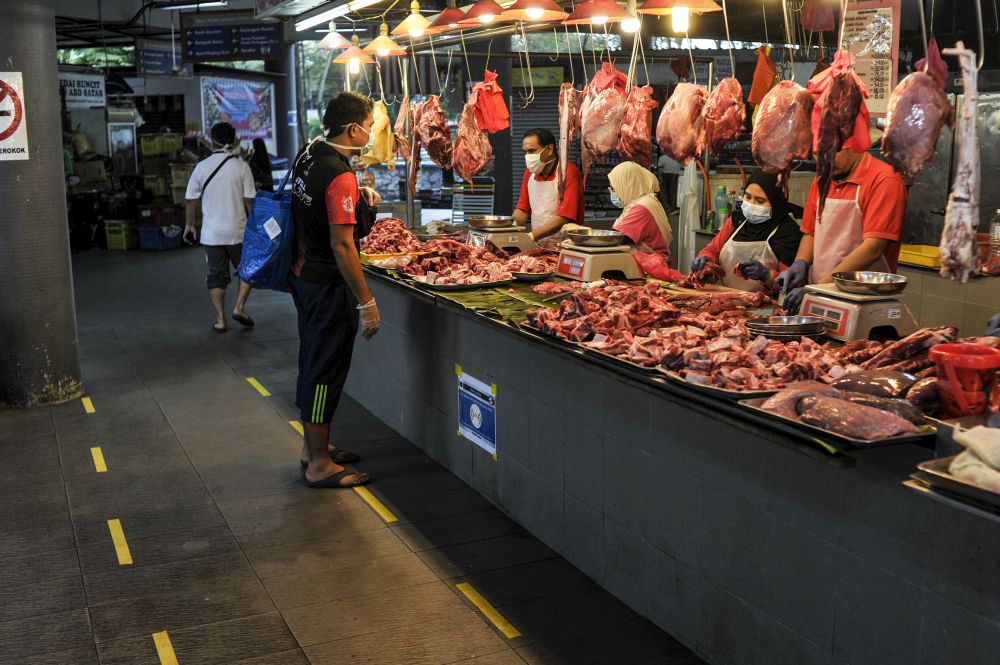 Yellow tape is pictured on the ground in front of a stall in Pasar Moden, Shah Alam to encourage social distancing March 23, 2020. u00e2u20acu201d Picture by Shafwan Zaidon
