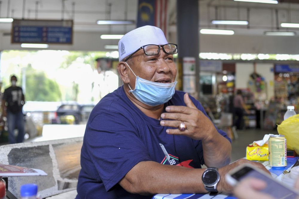 Vegetable stall owner M. Suhaimi Abdul Ghani, 62, is bracing for the impact of the MCO's plausible extension, understanding that it is a necessity to combat the Covid-19 pandemic. — Picture by Shafwan Zaidon