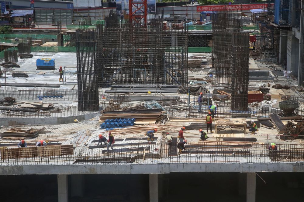 Workers are pictured at the construction site of Pavilion Damansara Heights March 18, 2020. u00e2u20acu201d Picture by Choo Choy May