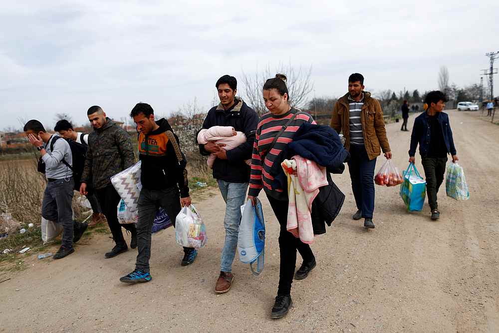 Migrants from Iran and Syria walk towards Turkey's Pazarkule border crossing with Greece's Kastanies, in Edirne, Turkey March 9, 2020. u00e2u20acu201d Reuters pic