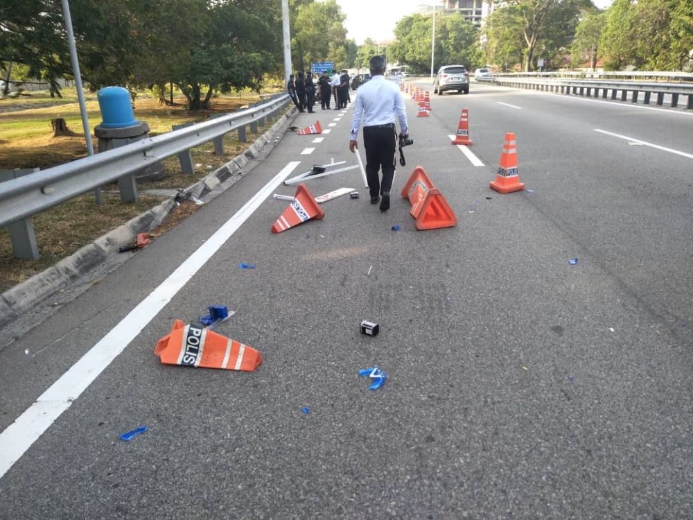 Shattered traffic cones can be seen after a Grab driver accidentally rammed into a roadblock on the Tun Dr Lim Choong Eu Highway in Penang  March 19, 2020. — Picture courtesy of PDRM