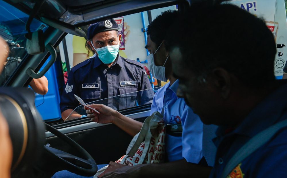 Police personnel inspect a vehicle at a roadblock on Jalan Tun Dr Awang in Penang on Day Two of the movement control order March 19, 2020. u00e2u20acu201d Picture by Sayuti Zainudin