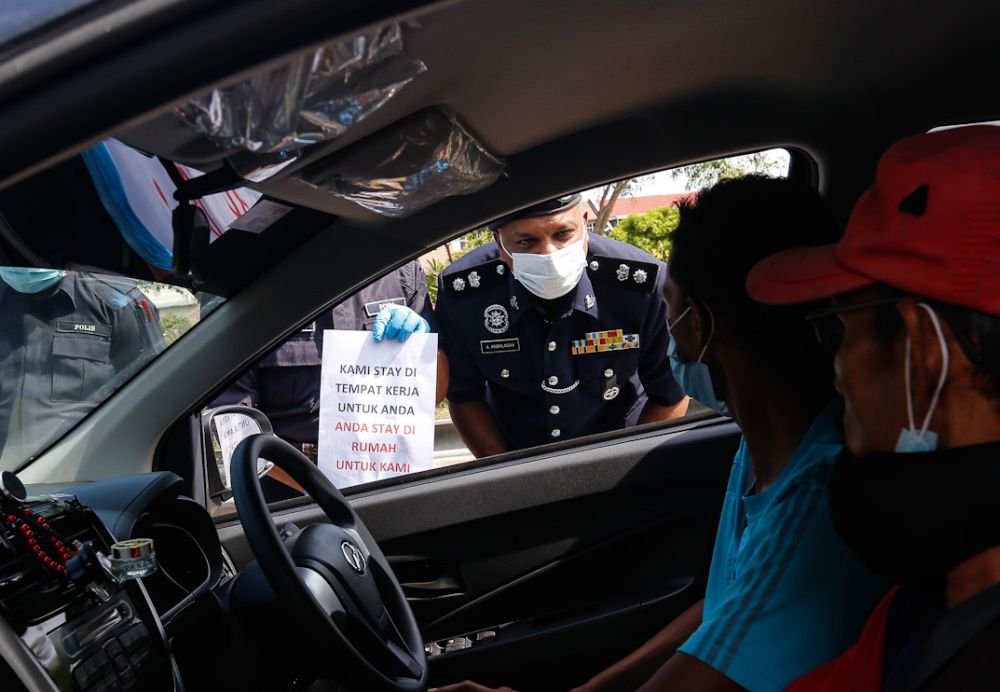 Police personnel inspect a vehicle at a roadblock on Jalan Tun Dr Awang in Penang on Day Two of the movement control order March 19, 2020. u00e2u20acu201d Picture by Sayuti Zainudin