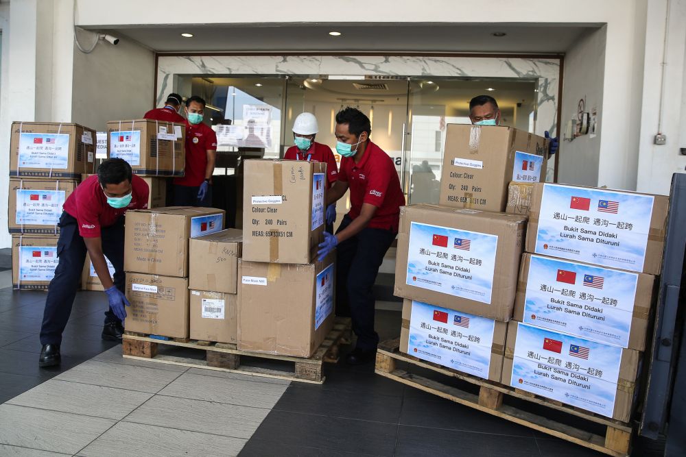 Pharmaniaga staff unload boxes of medical supplies donated by the Chinese Embassy in Shah Alam March 24, 2020. u00e2u20acu201d Picture by Yusof Mat Isa