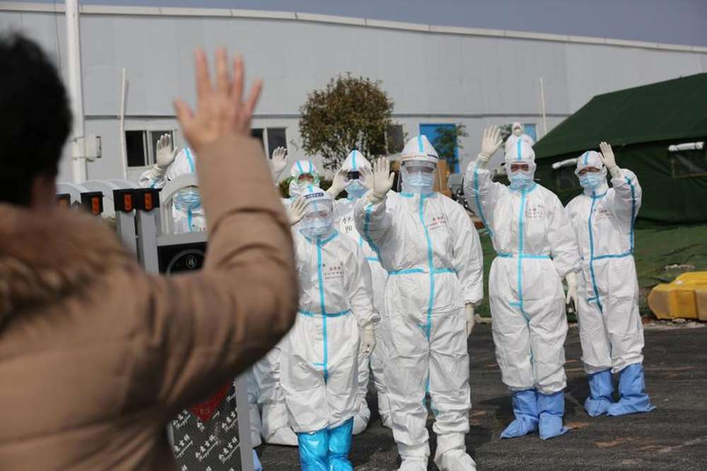 nnMedical personnel in protective suits wave hands to a patient being discharged from the Leishenshan Hospital after recovering from the coronavirus, in Wuhan, March 1. u00e2u20acu201d China Daily pic via Reuters