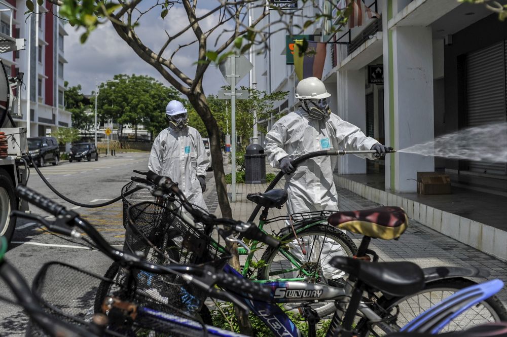 An Alam Flora personnel sprays disinfectant in Putrajaya to curb spread of Covid-19 March 31, 2020. u00e2u20acu201d Picture by Shafwan Zaidon