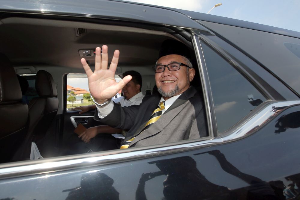 Perak PAS commissioner Razman Zakaria waves to reporters as he leaves Istana Kinta March 10, 2020. u00e2u20acu201d Picture by Farhan Najib