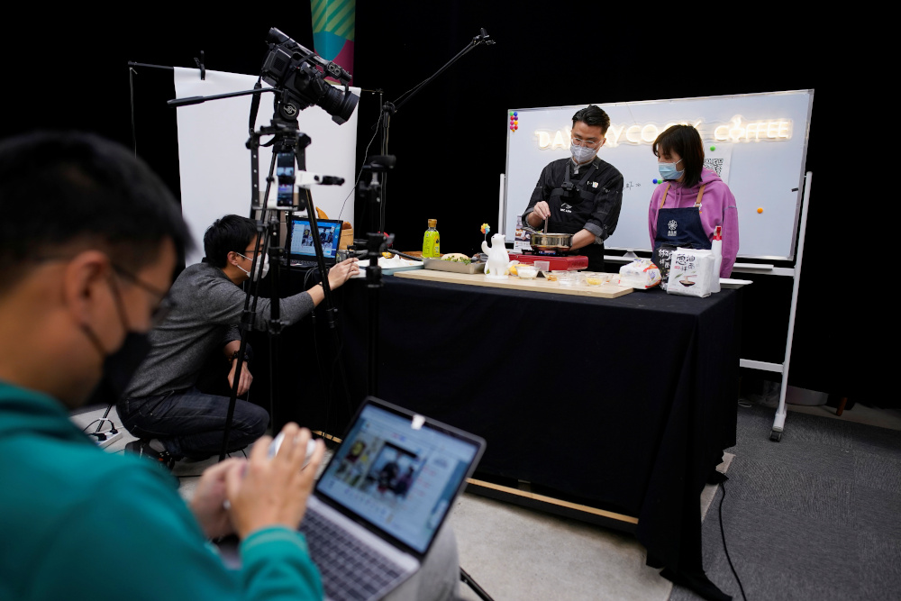 Chefs wearing face masks conduct a cooking lesson through a live-streaming session inside a restaurant at an office as the country is hit by an outbreak of the novel coronavirus that can cause Covid-19 disease, in Shanghai March 9, 2020. u00e2u20acu201d Reuters pic