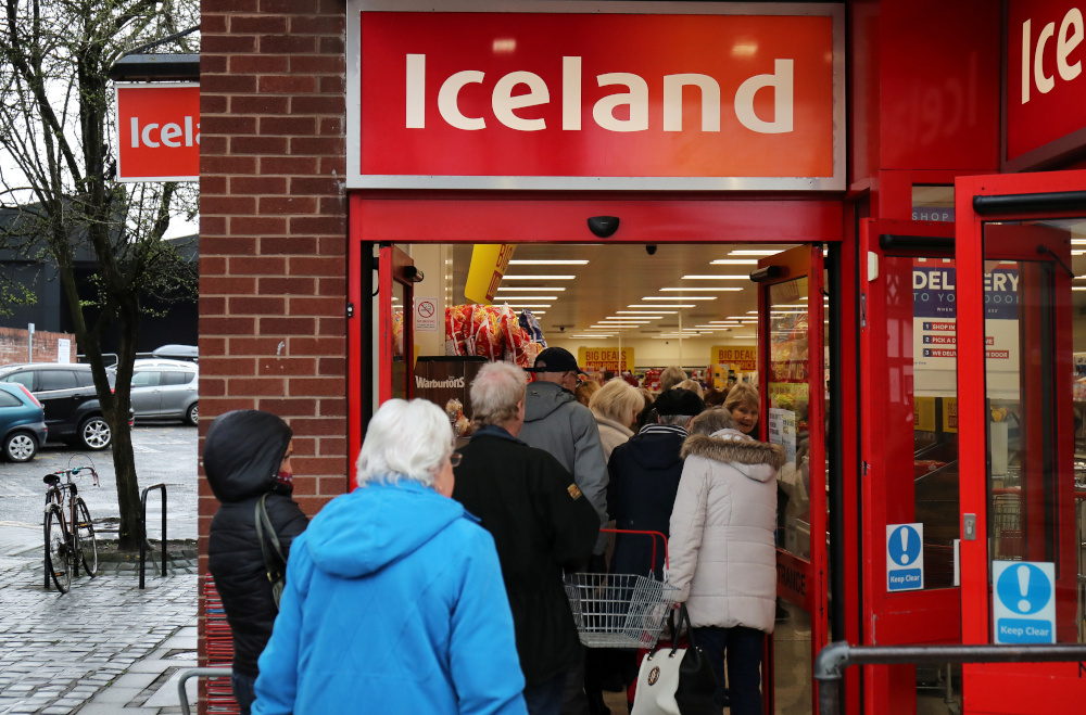 People queue outside an Iceland store in Northwich opening one hour early to allow elderly shoppers to buy food as the spread of the coronavirus disease (Covid-19) continues, in Northwich March 18, 2020. u00e2u20acu201d Reuters pic