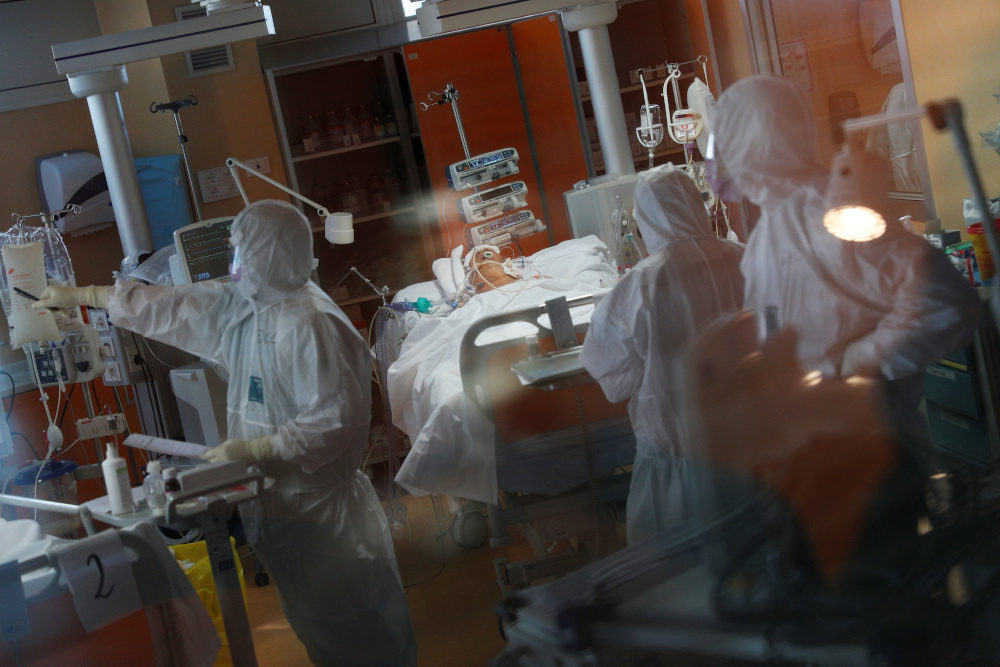 Medical workers in protective suits treat a patient suffering with coronavirus disease (Covid-19) in an intensive care unit at the Casalpalocco hospital, a hospital in Rome that has been dedicated to treating cases of the disease March 24, 2020. u00e2u20acu201d Reute