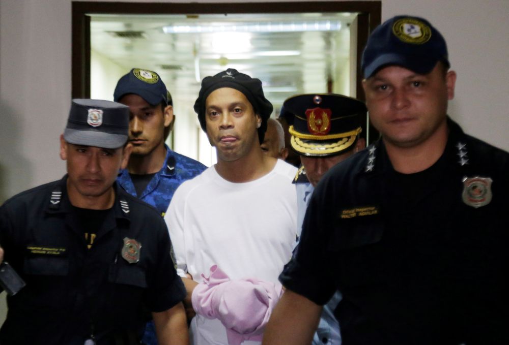 Ronaldinho is handcuffed and escorted by police at the Supreme Court of Paraguay in Asuncion March 7, 2020. u00e2u20acu201d Reuters pic
