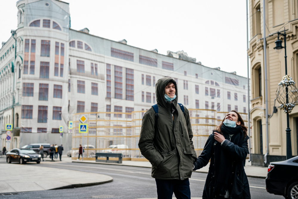 A couple with facemasks on their chins walks in downtown Moscow March 4, 2020. u00e2u20acu201d AFP pic 