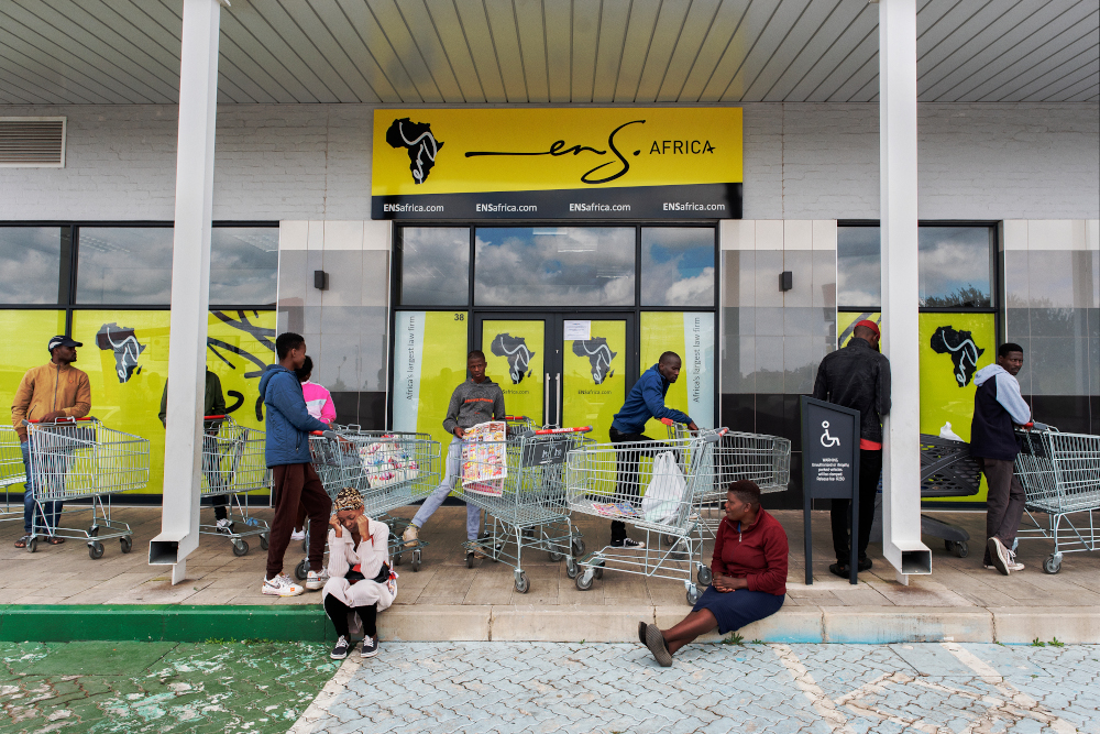 People queue to buy goods in Alexandra Mall, on March 28, 2020, during the second day of the 21 day national lockdown announced by South African President, Cyril Ramaphosa, to combat the spread of the Covid-19 coronavirus outbreak. u00e2u20acu201d AFP pic 