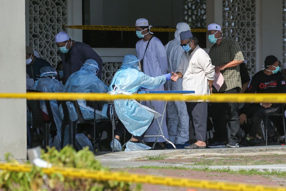 People wait for their turn to be tested for Covid-19 at the Section 7 Mosque in Shah Alam March 26, 2020. u00e2u20acu201d Picture by Yusof Mat Isa