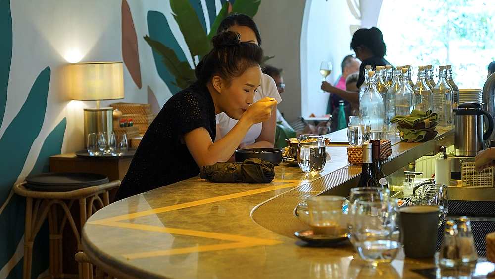 Customers dine next to yellow tape, marking social distancing imposed recently to curb Covid-19, at the bar of Merci Marco, a French restaurant chain in Singapore, March 25, 2020. u00e2u20acu201d Reuters pic 